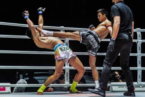 Superlek Kiatmoo9 evades a kick from Panpayak JItmuangnon at ONE: 'No Surrender' in Bangkok 