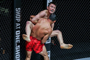 Shinya Aoki attempts a flying guillotine on Eduard Folayang