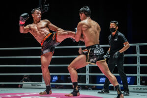 Superbon kicks Sittichiai Sitsongpeenong in a kickboxing contest in Bangkok