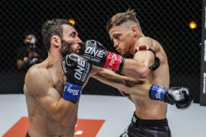 Enriko Kehl punches Davit Kiria during their featherweight kickboxing Grand Prix semi final bout at ONE: 'First Strike'