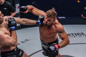 Anatoly Malykhin throws a right hand at Kirill Grishenko in their interim heavyweight title fight at the Singapore Indoor Stadium.