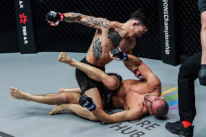 Thanh Le punches Garry Tonon during their featherweight title fight at ONE: 'X' at the Singapore Indoor Stadium